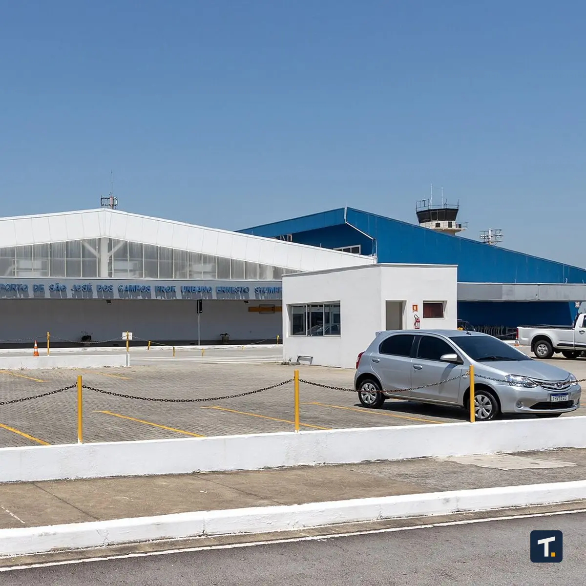 Trabalhador em galpão logístico e industrial operando equipamentos de movimentação de cargas.